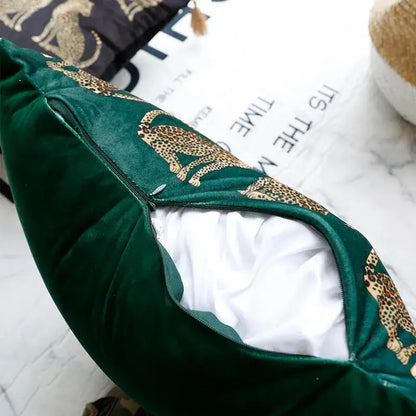Dark green velvet cushion cover with gold decorbites leopard cheetah print and zipper opening showing white lining