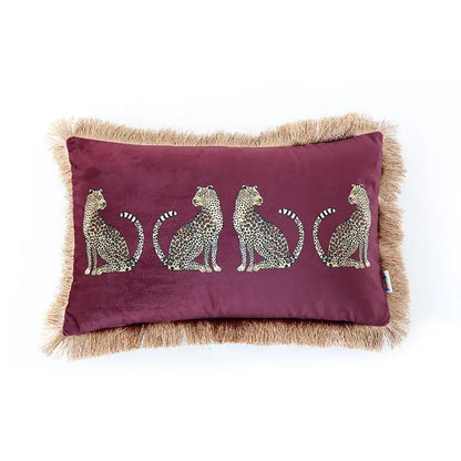 A plush maroon velvet cushion cover with embroidered leopard cheetah print and tan fringe from decorbites for living room decor