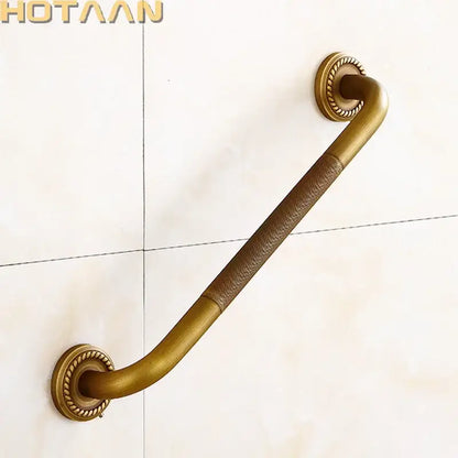 Decorative brass bathroom safety grab bar with brown leather wrap and ornate mounts for toilet safety grab bar use
