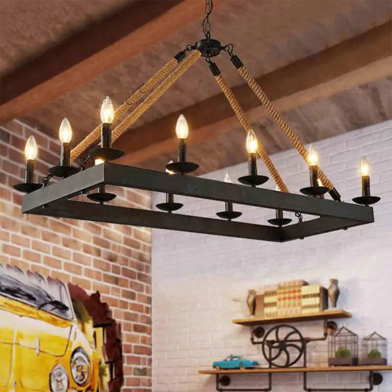 Industrial-style black metal chandelier with six lit e26 e27 candle-shaped bulbs suspended by natural rope