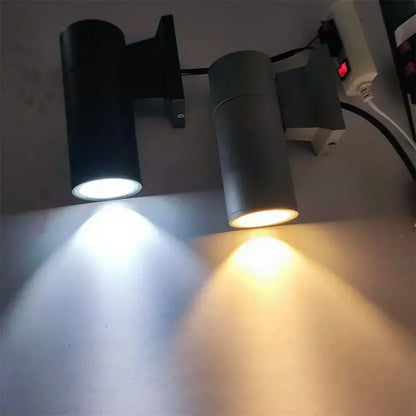 Modern black cylindrical 10w light wall outdoor porch spotlight with adjustable heads emitting white and warm yellow light