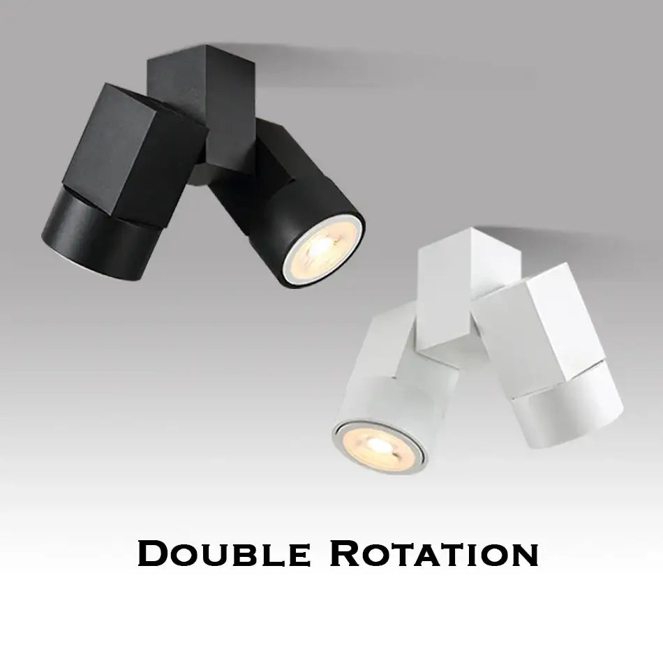 Modern white surface mount downlight with black and white double rotation spotlights featuring angular geometric design