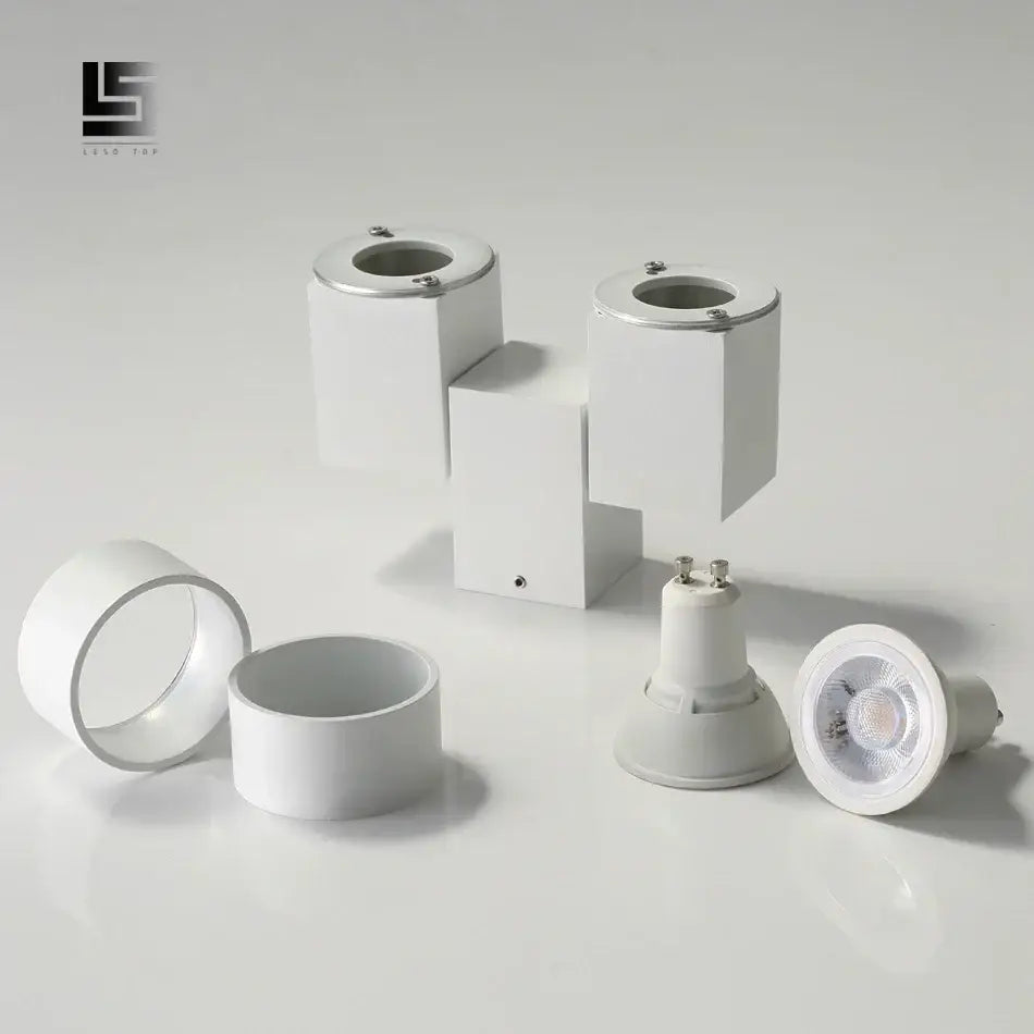 Modern white surface mount downlight with geometric design and metallic accents for living room lighting