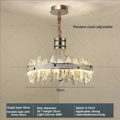 A modern luxury villa crystal chandelier with a metallic frame and clear and green crystal pieces for living room