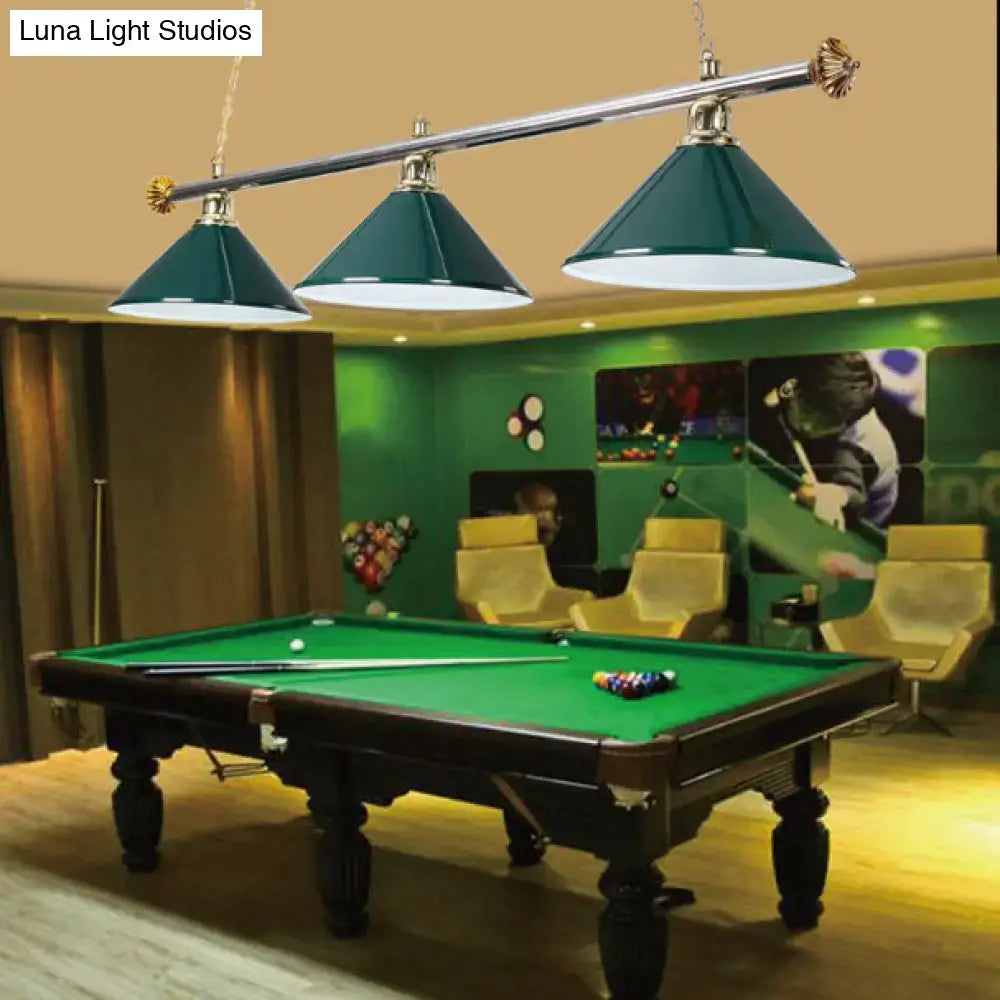 Teal-green conical metallic billiard light with brass accents hanging above a pool table indoor lighting fixture