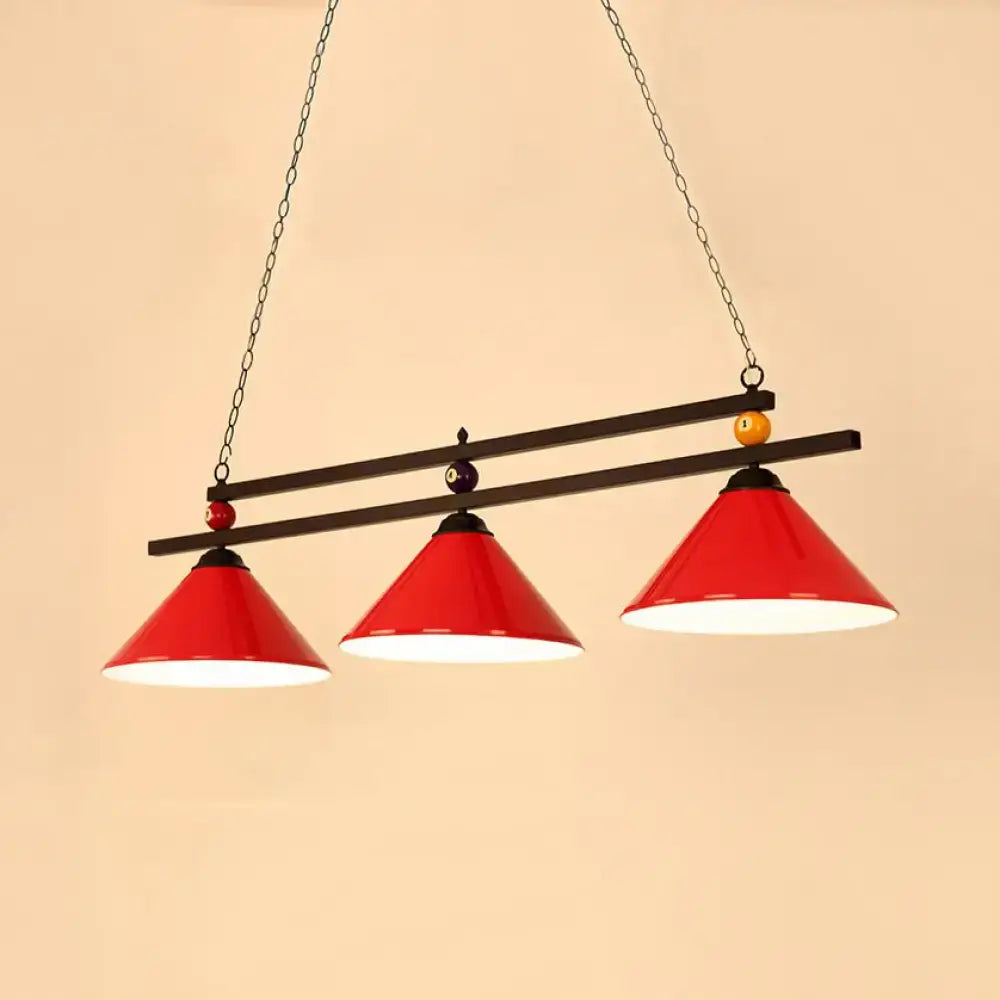 Red conical pendant lighting fixture with black metal frame chain suspension and pool ball accents for indoor use