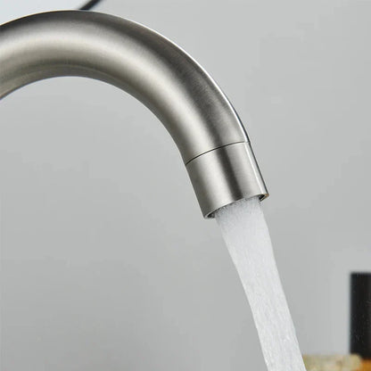 DecorBites 304 stainless steel rotating bathroom sink faucet with sleek brushed finish and curved spout flowing water