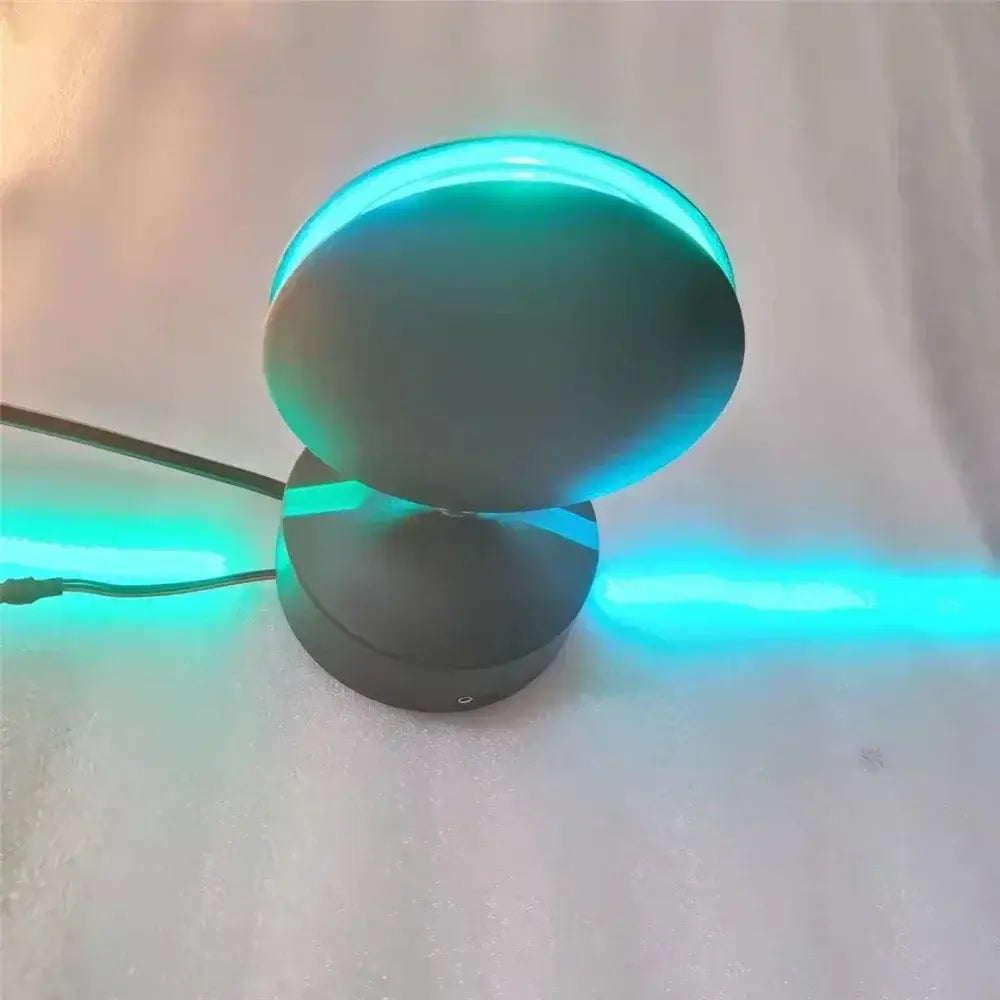 Modern black led wall lamp with circular design and teal light accents ideal for window wall lighting in hallways