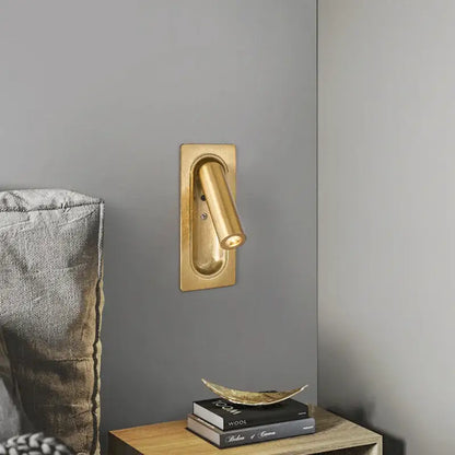 Modern brass and black led mounted headboard wall light with gold-finished cylindrical head and rectangular base decorbites 3w led wall light