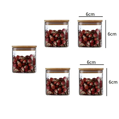 Decorbites 5oz glass jars set with clear glass and bamboo lids filled with dried red flowers for storage