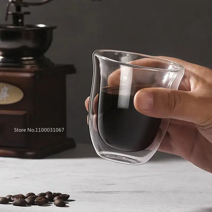 Clear double wall glass coffee mug held in hand filled with dark liquid from decorbites double wall coffee mugs set