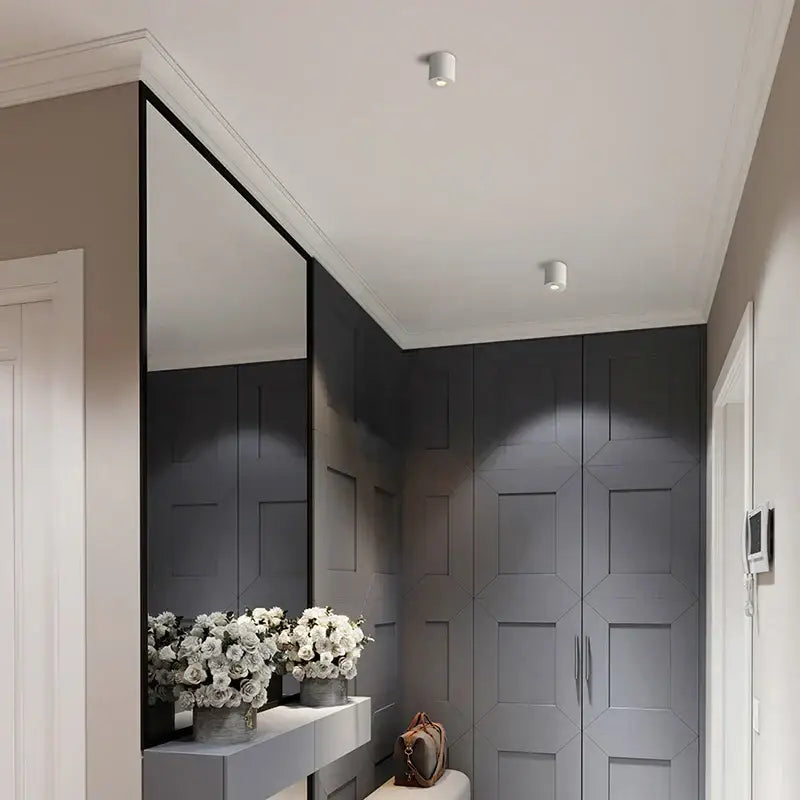 A brown leather handbag on a white bench next to a white decorbites™ 5w led sensor downlight with human body detection