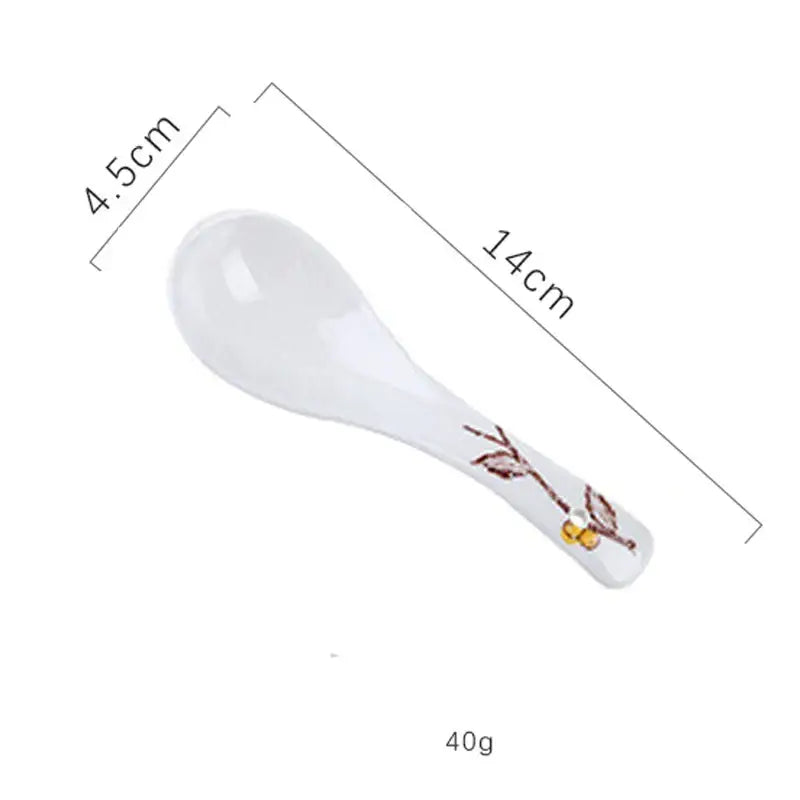 White ceramic spoon with brown and gold branch design handle included in decorbites retro ceramic ramen bowl set
