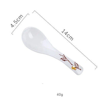 White ceramic spoon with brown and gold branch design handle included in decorbites retro ceramic ramen bowl set