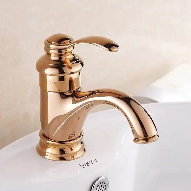 Decorbites 6 inch antique brass basin faucet with gold-toned polished brass single-handle and ornate base