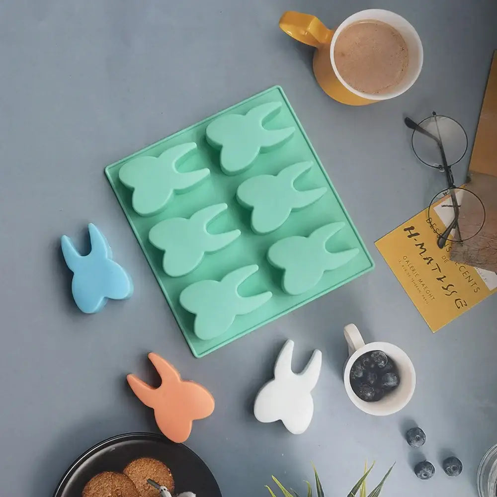 Mint green silicone mold featuring six bunny-shaped cavities from decorbites™ hole tooth silicone bakeware collection