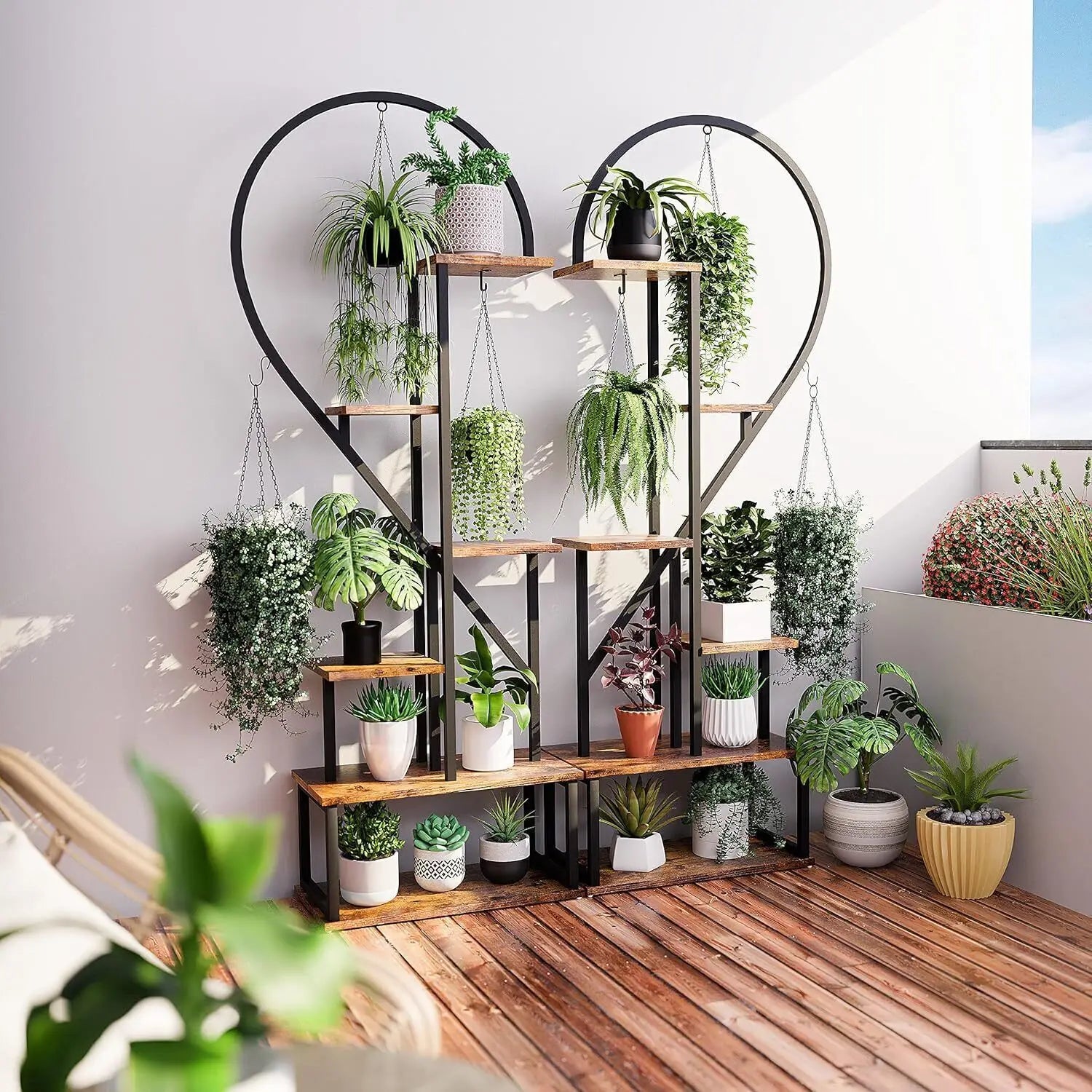 DecorBites 6-tier heart shaped plant display stand with wooden shelves and black metal frame holding potted plants