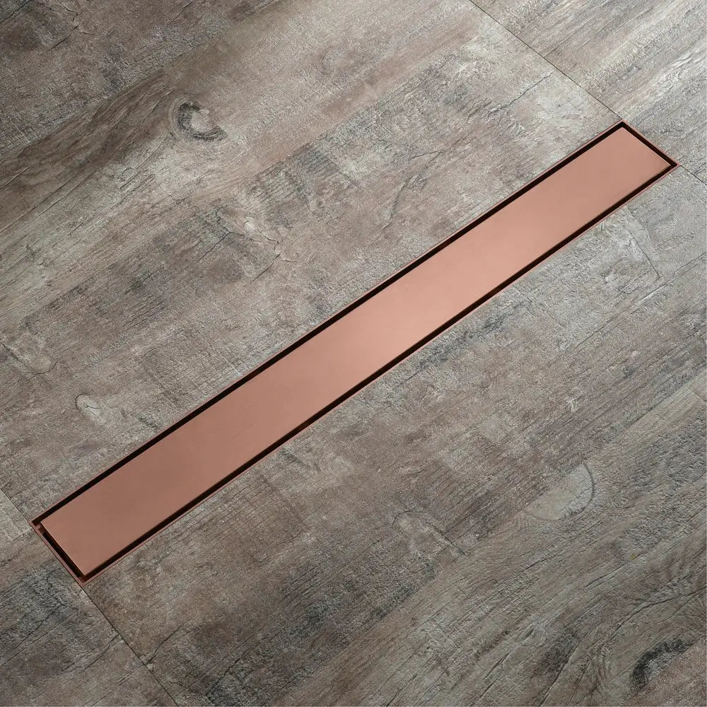 Decorbites 60cm rose gold bathroom floor drain strainer copper color sleek modern design set in gray wood flooring