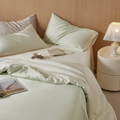 Soft mint green satin decorbites 60s rayon silk bedding set with matching pillowcases elegantly draped on bed