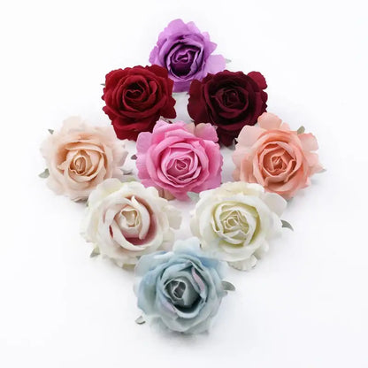 A collection of decorbites™ 6cm roses head artificial flowers in soft pastel and deep hues made from fabric petals