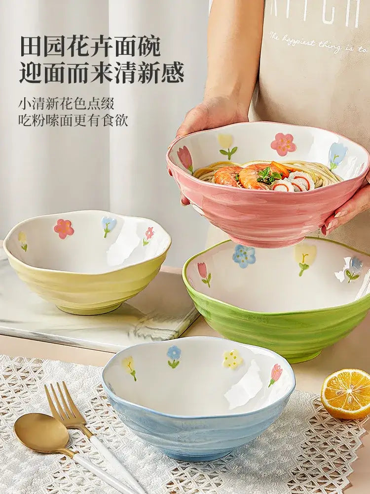 Pink hand-painted ceramic ramen bowl with floral design holding noodles and shrimp for home and restaurant use