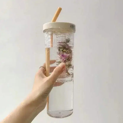 Clear plastic decorbites 700ml filtered water bottle with beige lid bamboo straw filled with water and dried flowers