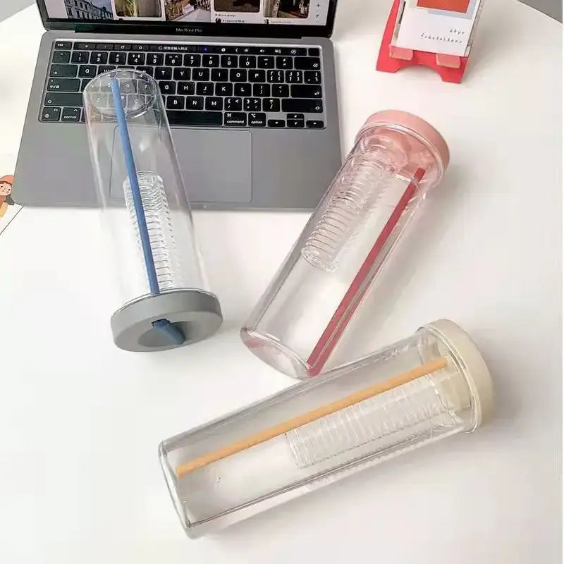 Three clear double-walled decorbites 700ml filtered water bottles with gray pink and beige lids and colored straws ideal for outdoors