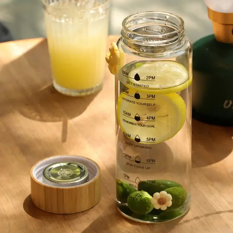 Decorbites 700ml glass water bottle with time marker bamboo lid and stainless steel tea filter with lemon slices