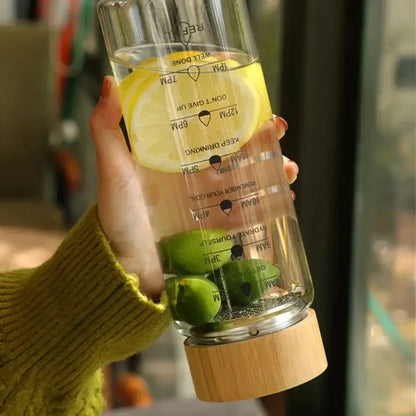 DecorBites™ 700ml glass water bottle with wooden base, time scale, stainless steel tea filter, lemon and lime inside
