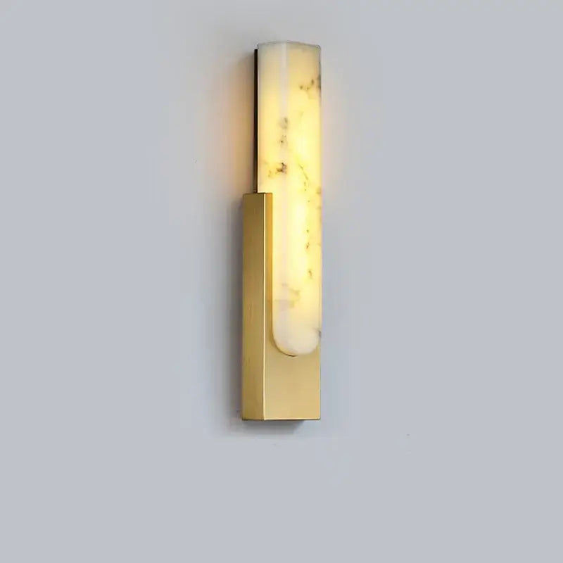 A sleek decorbites 7w led wall lamp with a gold brass frame and illuminated translucent onyx led marble wall panel