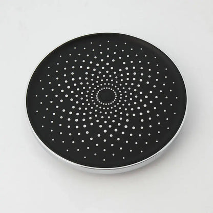 Black circular wireless charging pad with silver metallic rim and white perforated dots for stainless steel shower set