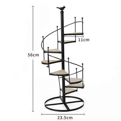 Black metal spiral staircase plant stand with wooden steps and bird finial featuring iron frame and wood plate design