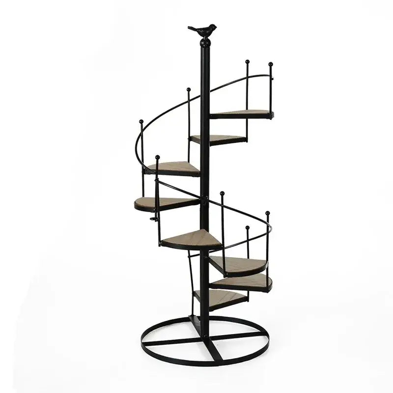 Black metal spiral stair shape plant stand with wood plate shelves and bird finial top by DecorBites