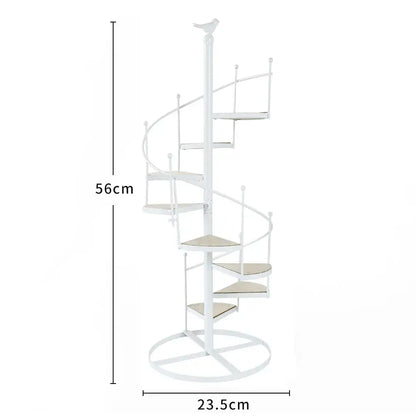 White spiral stair shape iron plant stand with beige cushioned steps wood plate and bird finial top by DecorBites