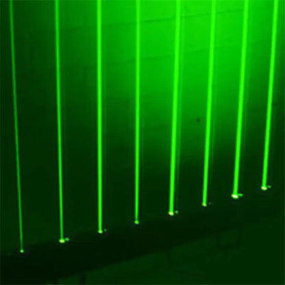 Vertical green laser beams from the DecorBites™ 8-lens rgb laser array moving head light illuminate a dark stage space