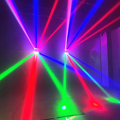 Vibrant red blue green and purple beams from two ceiling-mounted decorbites 8x15w rgbw spider lights in a dark room
