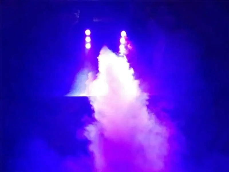 Decorbites™ 900w fog machine emitting vibrant purple and blue smoke under stage lights for weddings and parties