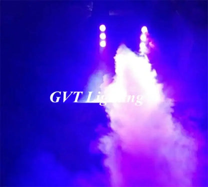 Purple and white stage smoke rising from decorbites 900w led fog machine with colorful spray light under blue lighting