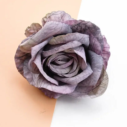 A delicate handcrafted 9cm silk rose in muted purple and gray showcasing textured layered petals for artificial flowers decor
