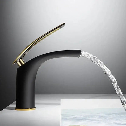 Modern black and gold faucet with a sleek curved design complementing the stainless steel gold dustbin by decorbites