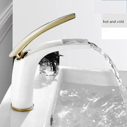White ceramic faucet with sleek gold tone spout and handle complements stainless steel gold dustbin by DecorBites