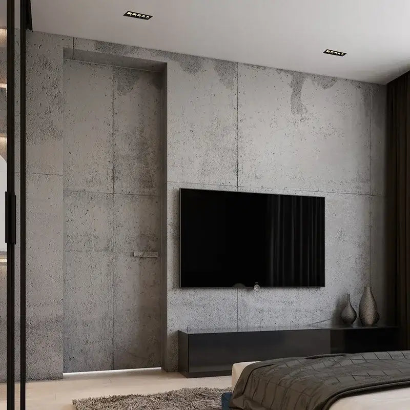 Black flat-screen television mounted on textured concrete wall illuminated by decorbites recessed spot light downlight