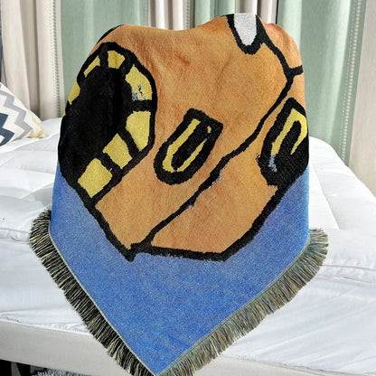 A decorbites abstract aesthetic triangular knit sofa blanket with a bold cartoon face on orange and blue edges