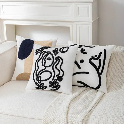 White throw cushion cover with black abstract art line embroidered stylized faces from decorbites abstract art collection