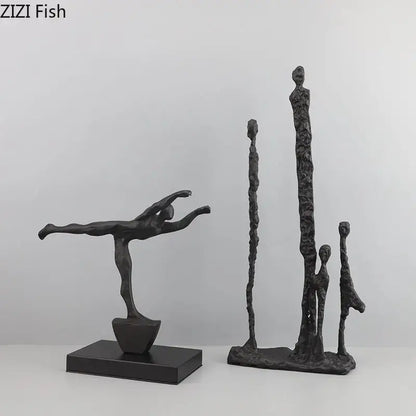 Decorbites abstract cast iron figure sculpture in black matte finish depicting a dancer in mid-leap pose on base