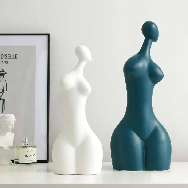 Two decorbites abstract ceramic sexy woman statues in white and teal blue with smooth glossy surfaces for modern decor