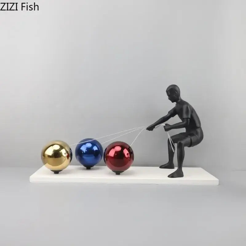 Black decorbites abstract character metal sculpture of person pulling three colorful reflective spheres for desk decor