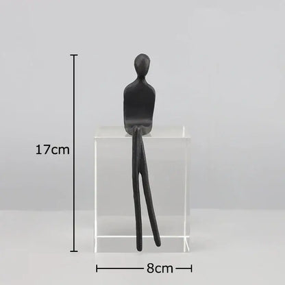 Black matte finished decorbites abstract character sculpture seated on crystal base for modern room decor