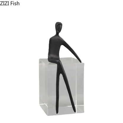 Black decorbites abstract character sculpture with elongated limbs resting on a crystal base for modern room decor