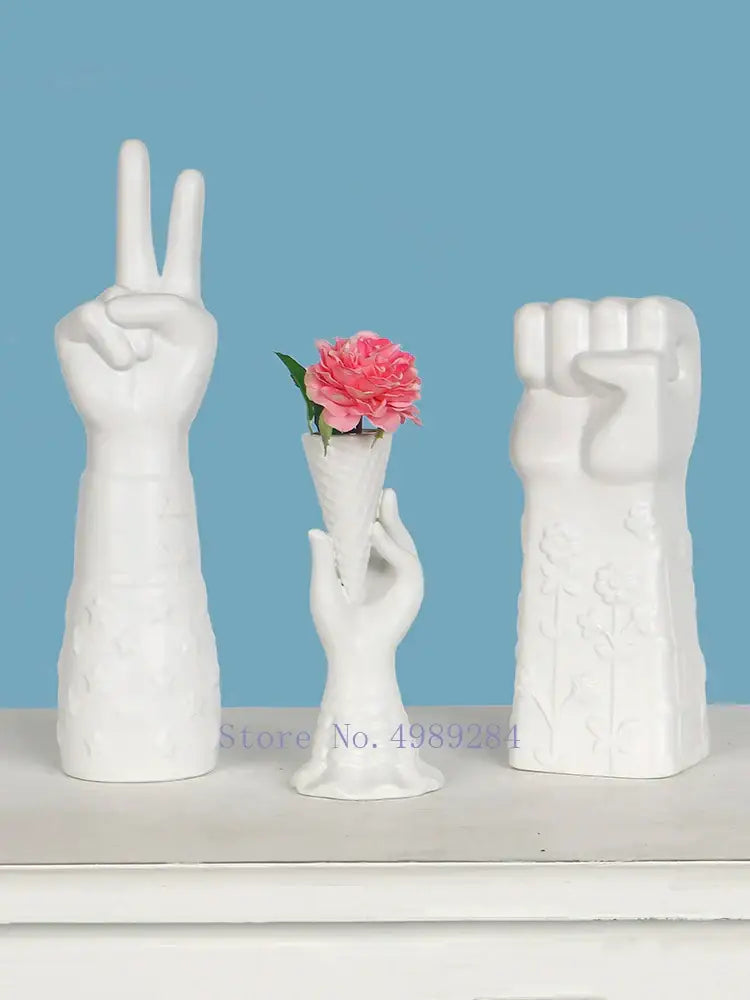 Decorbites abstract character white ceramics vase set with hand-shaped peace and fist gestures holding a pink carnation